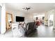 Open-concept living room with hardwood floors flowing seamlessly into a modern kitchen at 6133 Metrowest Blvd # 105, Orlando, FL 32835