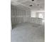 Spacious unfinished room, primed and ready for customization with drywall and exposed utilities at 1212 Avenue F, Haines City, FL 33844