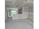 Unfinished room ready for customization, showing drywall, concrete floors, and natural light from a window at 1212 Avenue F, Haines City, FL 33844