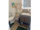 A modern bathroom with a wood vanity, open shelving, and a toilet at 734 Maryland Ave, Winter Park, FL 32789