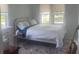 Bright bedroom with a large bed, windows, and floral rug at 734 Maryland Ave, Winter Park, FL 32789