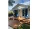Lovely home with a spacious deck and blue-accented doors, surrounded by lush landscaping at 734 Maryland Ave, Winter Park, FL 32789