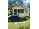 Charming home featuring a cozy porch, blue door, and well-maintained landscaping at 734 Maryland Ave, Winter Park, FL 32789