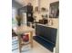 A modern kitchen with dark cabinetry, a kitchen island with seating, and white subway tile backsplash at 734 Maryland Ave, Winter Park, FL 32789