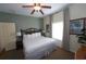 Comfortable bedroom with a queen-size bed, soft lighting, and a ceiling fan, providing a cozy retreat at 8125 Resort Village Dr # 5902, Orlando, FL 32821