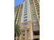 Exterior view of tall building, with multiple floors, balconies, and decorative columns at 8125 Resort Village Dr # 5902, Orlando, FL 32821