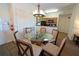 Dining area with round glass table and six chairs, adjacent to kitchen and entryway at 8125 Resort Village Dr # 5902, Orlando, FL 32821