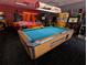 Game room features a pool table, air hockey, and various arcade games, offering residents diverse entertainment options at 8125 Resort Village Dr # 5902, Orlando, FL 32821