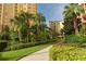 Beautifully landscaped community grounds with trees and a walking path at 8125 Resort Village Dr # 5902, Orlando, FL 32821