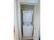 Convenient laundry closet featuring a stacked washer and dryer unit, providing in-home laundry solutions at 8125 Resort Village Dr # 5902, Orlando, FL 32821