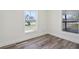 A sun-filled empty bedroom showcasing the flooring and natural light at 515 9Th St, Winter Garden, FL 34787