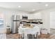 Bright eat-in kitchen features stainless steel appliances, white cabinetry, and breakfast nook at 515 9Th St, Winter Garden, FL 34787