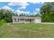 Single-story home boasting brick accents, black shutters and a well-manicured lawn at 562 Nardello Dr, Deltona, FL 32725