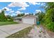Side view of a single-story home featuring a concrete driveway and a two-car garage at 562 Nardello Dr, Deltona, FL 32725