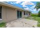 Back of house showing sliding glass doors, windows, and small patio area at 562 Nardello Dr, Deltona, FL 32725
