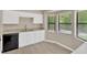 Bright kitchen area featuring white cabinets, modern appliances and lots of natural light at 562 Nardello Dr, Deltona, FL 32725