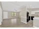 Spacious living room with modern flooring and a view into the adjacent kitchen at 562 Nardello Dr, Deltona, FL 32725