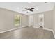 Spacious main bedroom with light gray flooring, ceiling fan, and en suite bathroom at 562 Nardello Dr, Deltona, FL 32725
