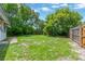Expansive backyard area with green grass and a wooden fence for privacy at 6906 Cocos Dr, Orlando, FL 32807