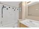 Bathroom featuring a shower-tub combo, tile accents, and a pedestal sink with a mirror at 6906 Cocos Dr, Orlando, FL 32807