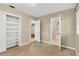 Cozy bedroom with terrazzo flooring, closet with shelving and two doorways at 6906 Cocos Dr, Orlando, FL 32807