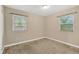 Simple bedroom with natural light from windows and neutral wall color at 6906 Cocos Dr, Orlando, FL 32807