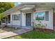 Close up of the home's front entrance, which is painted white and has a secure metal door at 6906 Cocos Dr, Orlando, FL 32807