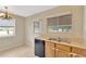 Bright kitchen features a double sink, black dishwasher, and a view to the back yard at 6906 Cocos Dr, Orlando, FL 32807