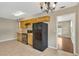 Functional kitchen featuring ample cabinetry, tile flooring, and black appliances in a clean design at 6906 Cocos Dr, Orlando, FL 32807