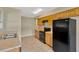 Well-lit kitchen with tile floors, oak cabinets, black appliances, and a stainless steel sink at 6906 Cocos Dr, Orlando, FL 32807