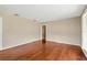 Open living area with hardwood floors, neutral walls, and view into the next room at 6906 Cocos Dr, Orlando, FL 32807