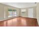 Bright living room featuring a large window with hardwood flooring and a white door at 6906 Cocos Dr, Orlando, FL 32807