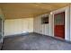 Enclosed porch featuring concrete floors, access to outdoors and additional storage at 6906 Cocos Dr, Orlando, FL 32807