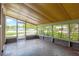Screened porch offering natural light and views to the street and backyard at 6906 Cocos Dr, Orlando, FL 32807