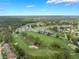 A scenic aerial view of a golf course community with lush greenery and lakes at 414 Long Cove Ct, Ormond Beach, FL 32174