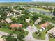 Overhead view of residences showcasing mature landscaping near a golf course at 414 Long Cove Ct, Ormond Beach, FL 32174
