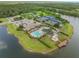 Bird's-eye view of a community with a pool, clubhouse, tennis courts, and picturesque landscaping at 414 Long Cove Ct, Ormond Beach, FL 32174