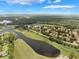 A panoramic view of a golf course community, showcasing a harmonious blend of natural beauty and elegant homes at 414 Long Cove Ct, Ormond Beach, FL 32174