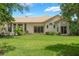 A backyard view of the property's exterior, highlighting the sliding glass doors that lead to the outdoor spaces at 414 Long Cove Ct, Ormond Beach, FL 32174