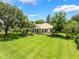 Expansive backyard with manicured lawn and lush green landscape at 414 Long Cove Ct, Ormond Beach, FL 32174