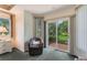Carpeted room features a chair, white dresser and sliding glass door to the outside at 414 Long Cove Ct, Ormond Beach, FL 32174