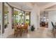 Sunlit breakfast nook featuring a charming table set and large windows showcasing the lush outdoors at 414 Long Cove Ct, Ormond Beach, FL 32174