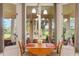 Bright breakfast nook with views of the golf course and access to the lanai through sliding glass doors at 414 Long Cove Ct, Ormond Beach, FL 32174