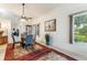 Elegant dining room with a glass table, stylish chairs, and natural light creating a welcoming ambiance at 414 Long Cove Ct, Ormond Beach, FL 32174