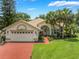 Inviting home with manicured landscaping, brick driveway, and charming curb appeal at 414 Long Cove Ct, Ormond Beach, FL 32174