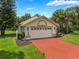 Charming home with a brick driveway and a well-manicured lawn at 414 Long Cove Ct, Ormond Beach, FL 32174