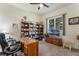 Cozy home office with built-in bookshelves and a large window overlooking the backyard at 414 Long Cove Ct, Ormond Beach, FL 32174