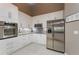 Well-equipped kitchen with stainless steel appliances, granite countertops, and pristine white cabinetry at 414 Long Cove Ct, Ormond Beach, FL 32174