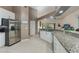Open kitchen featuring stainless steel appliances and a granite countertop island at 414 Long Cove Ct, Ormond Beach, FL 32174