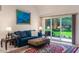 Bright living room featuring a sliding glass door to the yard and contemporary furnishings at 414 Long Cove Ct, Ormond Beach, FL 32174